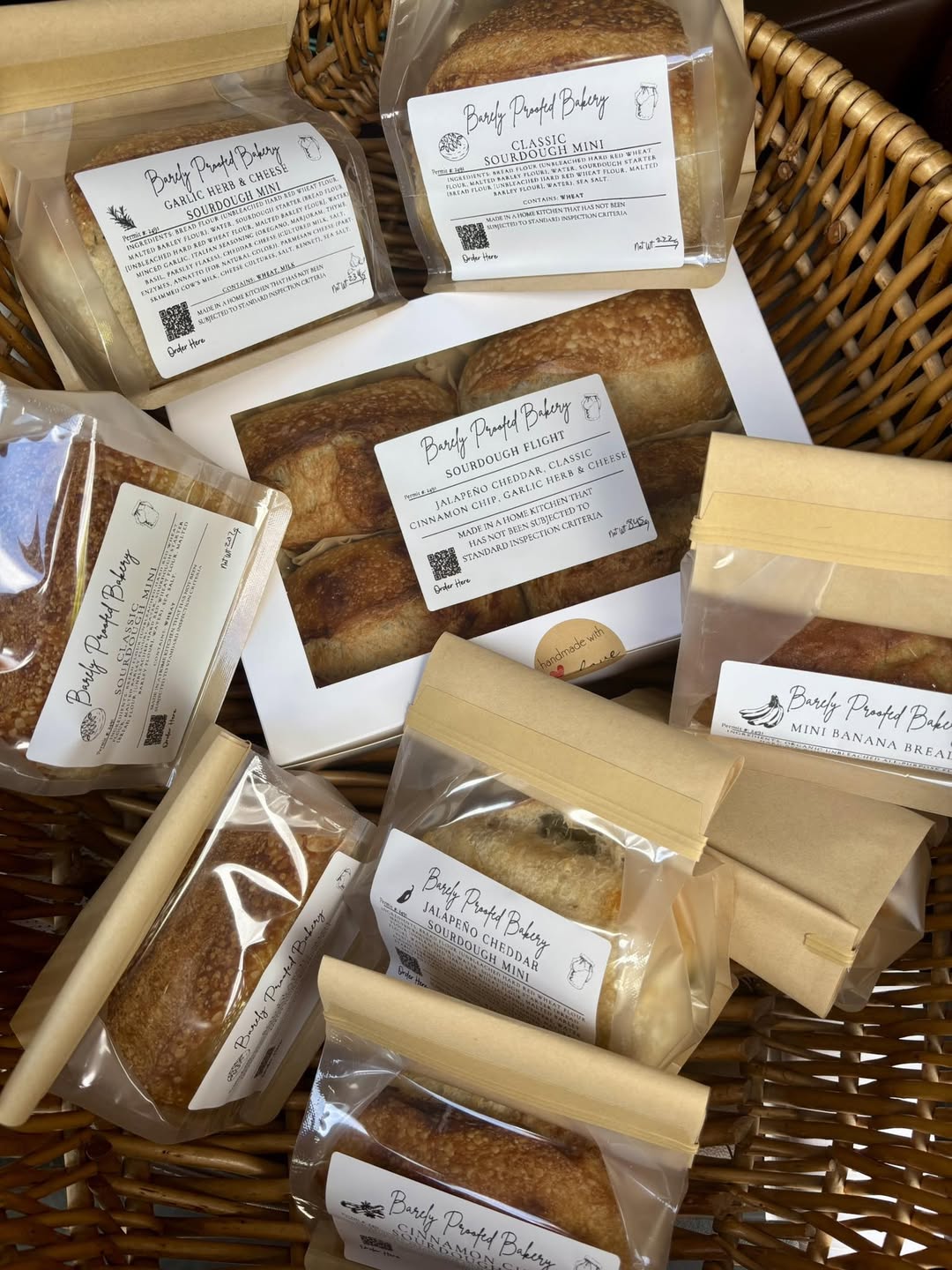 Basket of labeled Barely Proofed Bakery sourdough minis and banana bread